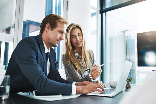 Engineers pairing on an application build in a bright office